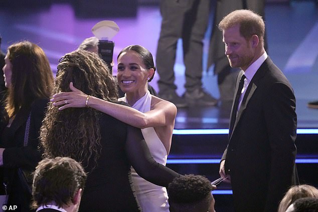 Before the ceremony began, Harry and Meghan were seen catching up with friends in the audience, with the Duchess leaning forward to give one of the attendees a big hug