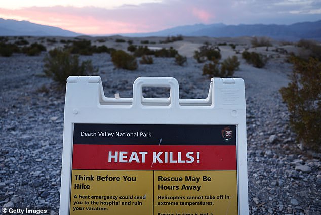 A sign with the text "Heat kills!" is seen during a prolonged heat wave that is affecting much of California