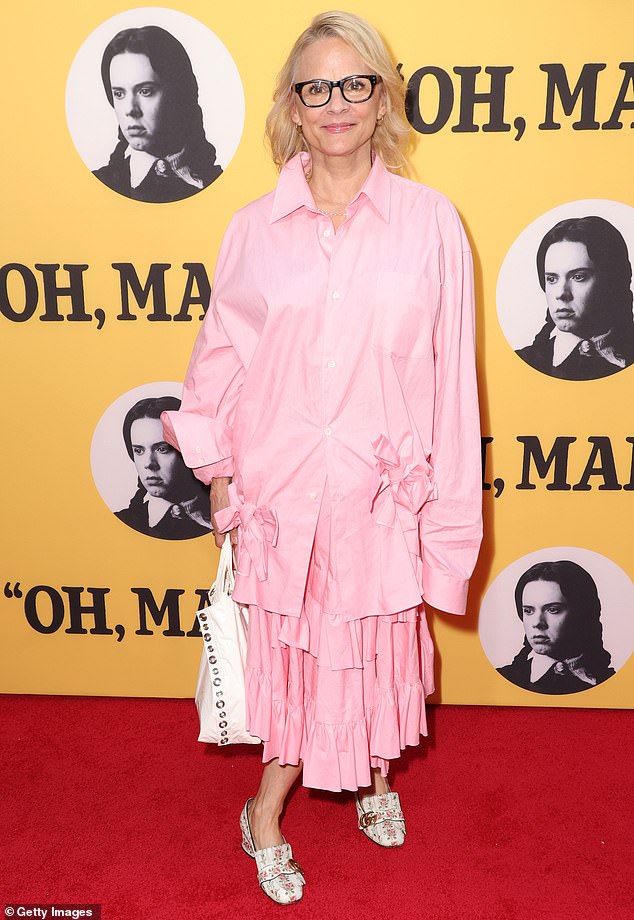 Amy Sedaris wore an oversized pink Oxford shirt with a matching pleated skirt and a pair of pink floral shoes