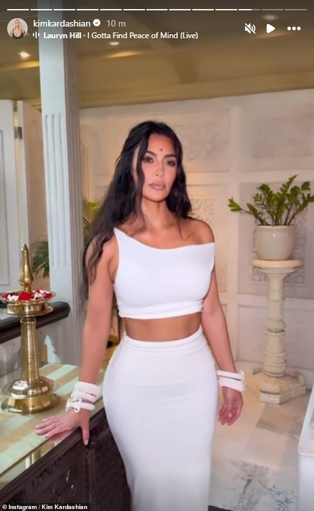 Kim shared a glamorous photo of her first wedding look on Instagram, which consisted of a white off-the-shoulder crop top and matching skirt