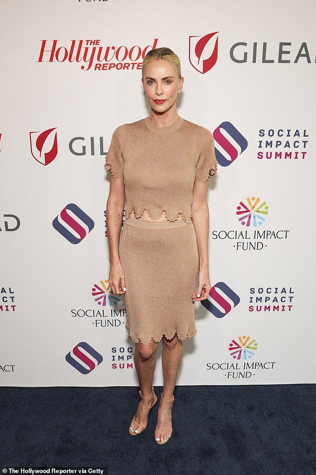 Theron opted for a nude ensemble featuring a short-sleeved top that exposed her toned waist