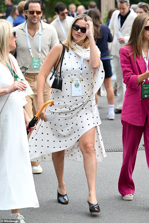 The 34-year-old actress looked utterly maternity-chic in a polka-dot dress as she carefully held her baby bump while walking hand-in-hand with Tom