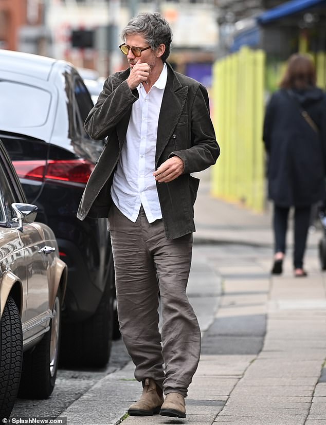 Jason looked smart and casual in a crisp white shirt and dark gray jacket as he strolled through Hale Village