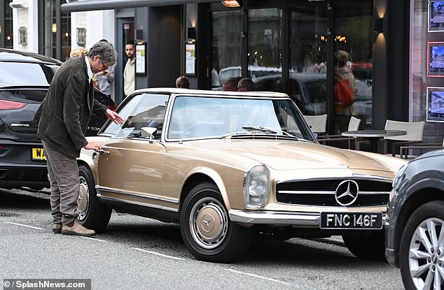 He teamed baggy trousers with a smart casual ensemble and wore a pair of suede ankle boots