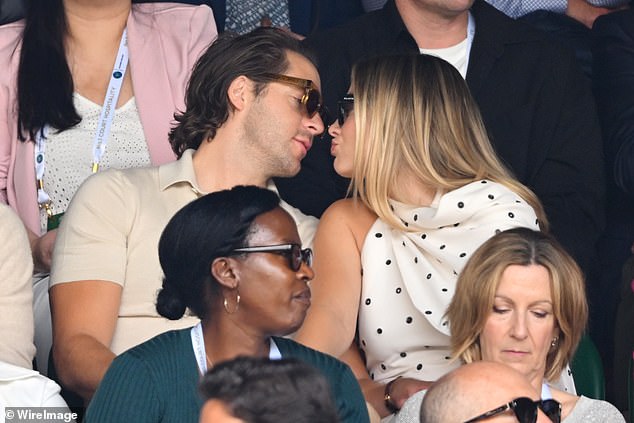 As they took their seats next to Hugh Grant and his wife Anna Elisabet Eberstein, the couple seemed more concerned with showering each other with affection than watching the game.