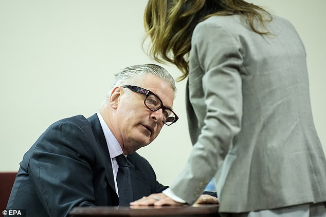 Baldwin speaks with his wife, Hilaria Baldwin, during his involuntary manslaughter trial in Santa Fe County Superior Court in Santa Fe