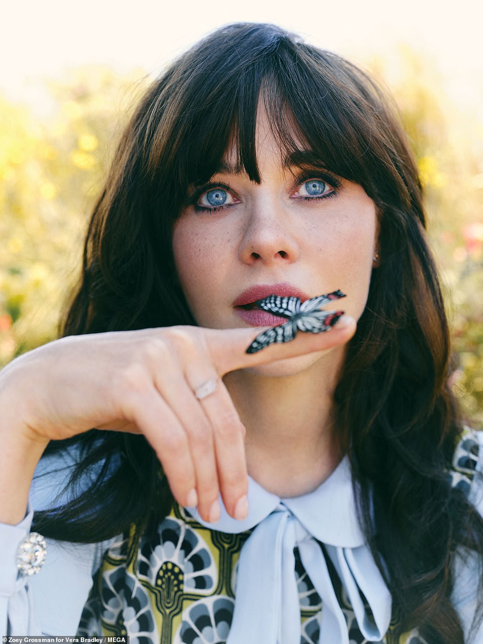 1720811516 179 Zooey Deschanel poses with a butterfly on her finger in