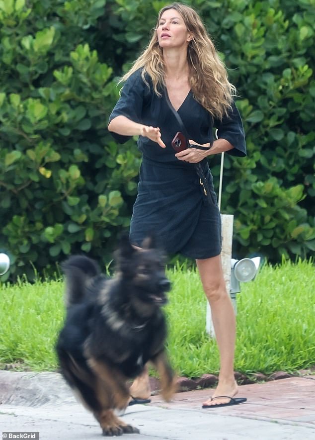 At another point during the day, Gisele was spotted getting another form of exercise by playing outside with one of her dogs