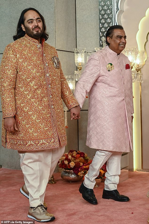 Anant, 29, the son of India's richest man Mukesh Ambani (seen together today before the wedding), and Radhika, 29, will tie the knot this afternoon