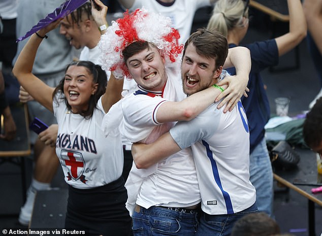 Cuddling helps release oxytocin - the so-called 'cuddle' or 'bonding' hormone. Pictured: England fans in Croydon after their opening goal at the European Championship against Ukraine, 3 July 2021