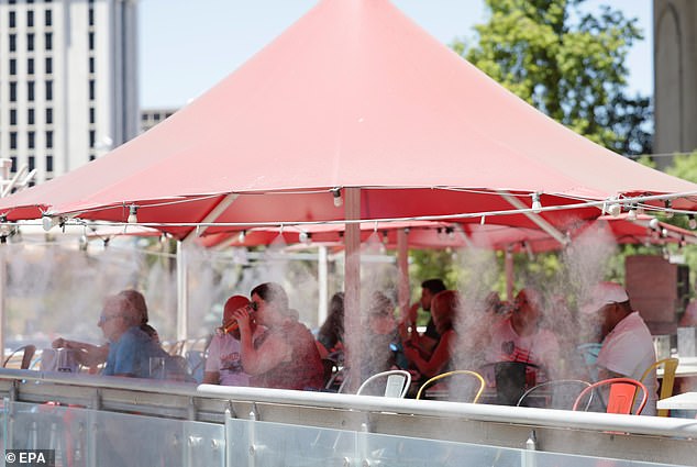 Visitors dine under fog to stay cool in record heat in Las Vegas as extreme heat warning issued