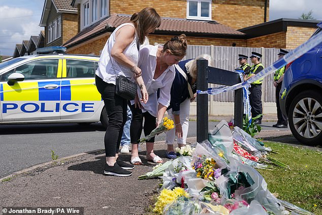 Friends and family members laid flowers at the spot where the three women were murdered