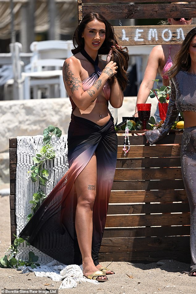 Jodie Wells showed off her tattooed skin in a colorful thigh-slit dress