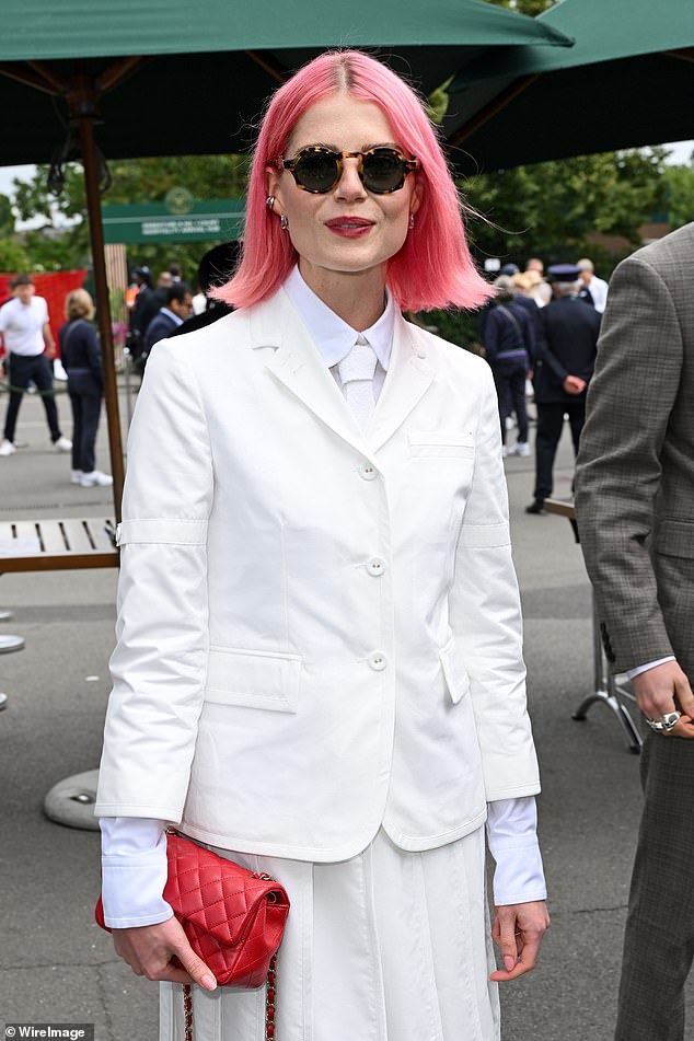 Lucy Boynton showed off her bright pink hair and dressed in a white suit for the outing