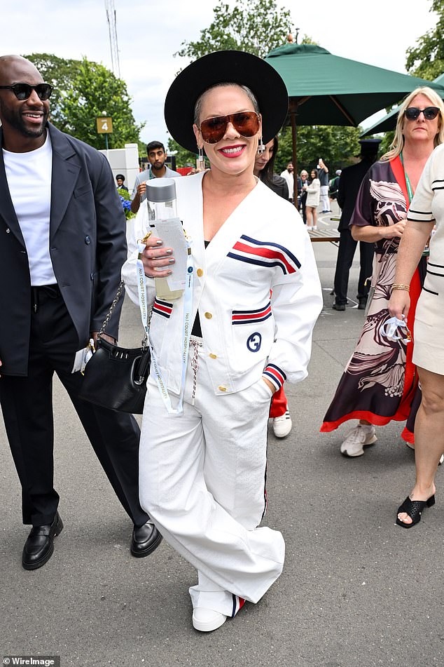 Pink looked typically stylish in a white Gucci jacket and matching pants