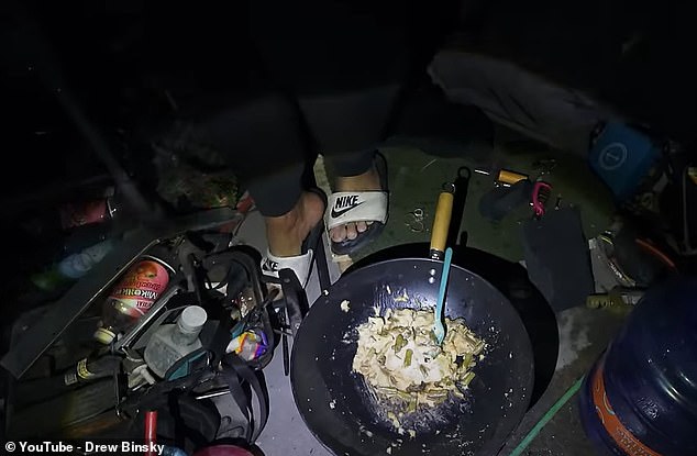 In the film, Drew's camera pans to show how the man has created a makeshift kitchen with a large pot placed over a wood fire