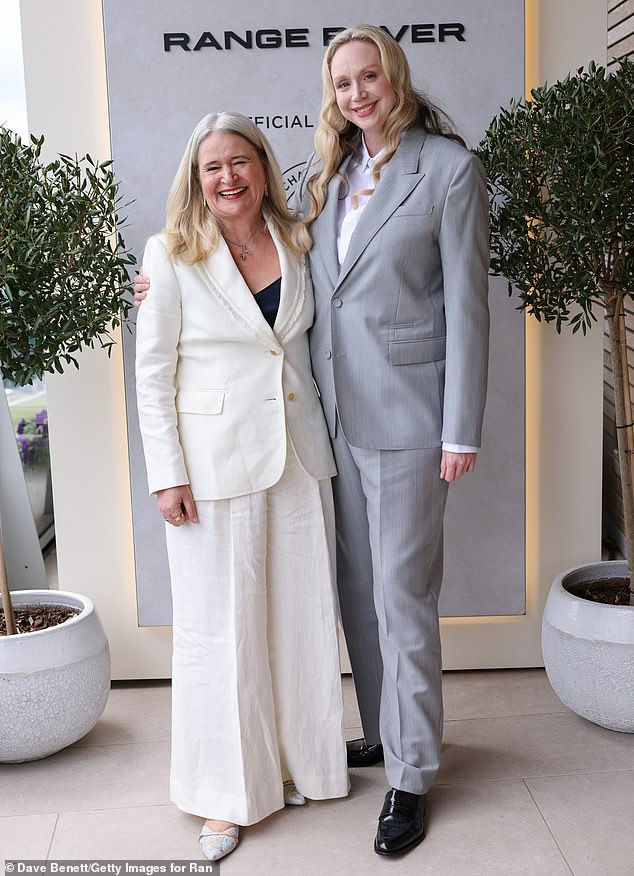 She teamed the smart suit with a pair of shiny black leather shoes as she posed with Harper's Bazaar editor-in-chief Lydia Slater