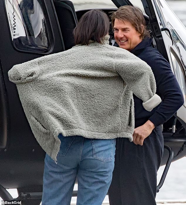 The couple appeared to be in high spirits after landing in London in Tom's helicopter