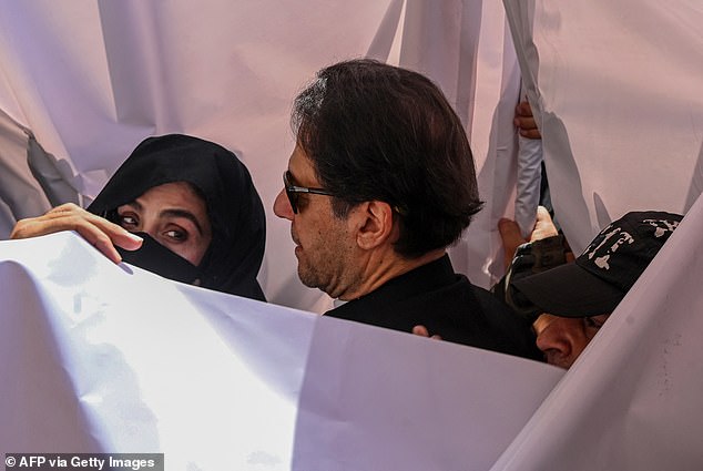 Former Pakistani Prime Minister Imran Khan and his wife Bushra Bibi arrive to appear at a high court in Lahore on May 15, 2023. Since then, Khan has been embroiled in more than 150 cases, including incitement to violence.