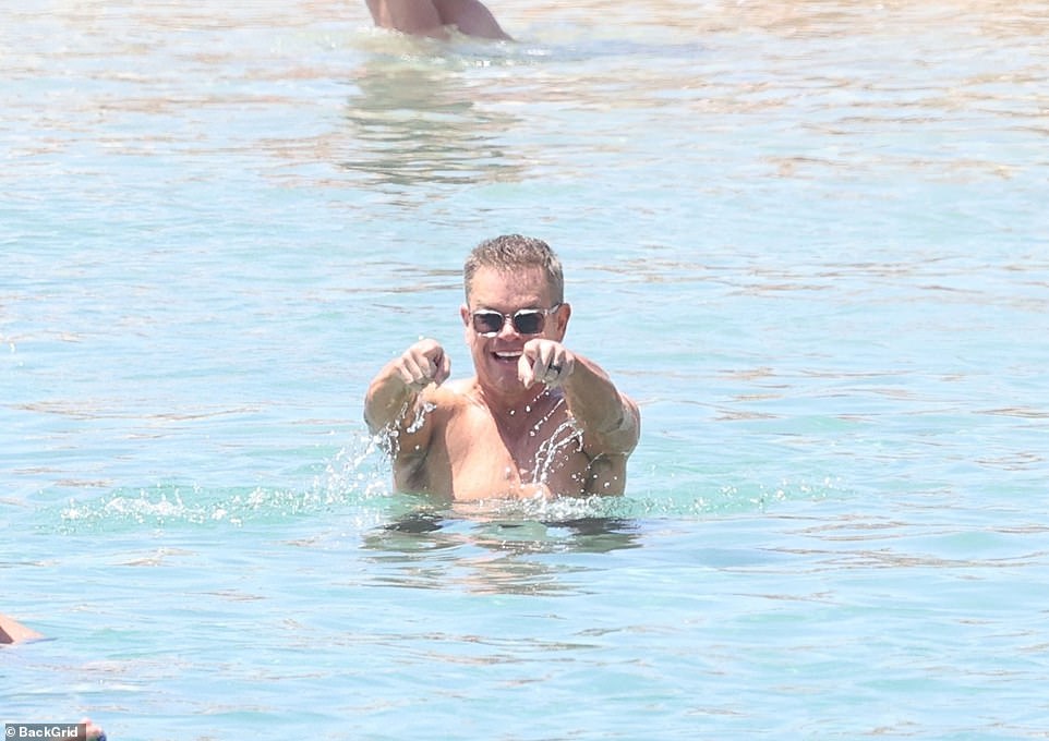 The couple were seen relaxing in side-by-side beach chairs, and having fun in the sand and the Aegean Sea.