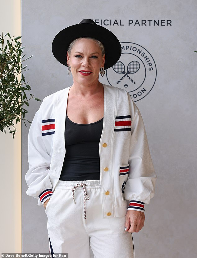 The 44-year-old Just Give Me a Reason hitmaker — who recently showed off her bikini body while on vacation — posed for photos in a white vest and pants with navy and red stripe detailing on the pockets and wrists of the outfit