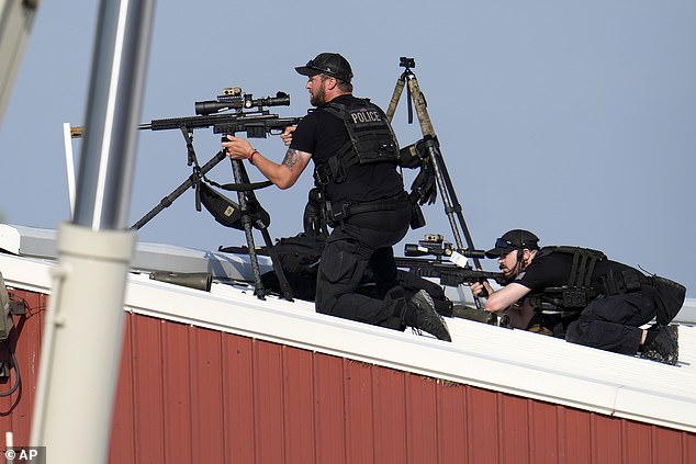 The footage shows officers on top of a building above the rally stage in Butler, Pennsylvania, as shots rang out. Photos show officers on the roof