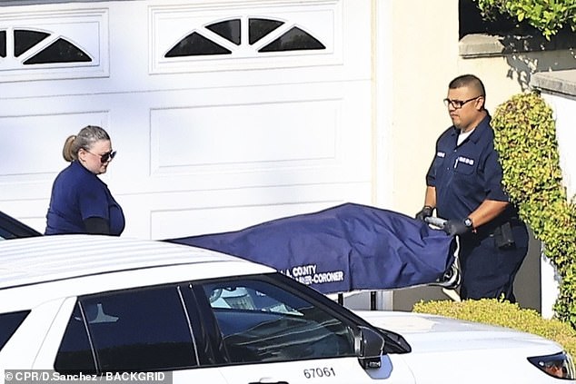 Photos show the coroner carrying Simmons' body out of his home on a stretcher