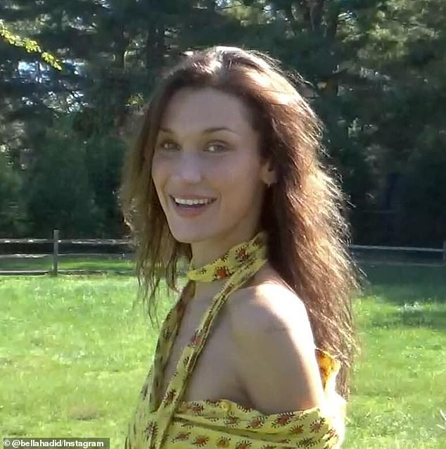 The supermodel was said to have a big smile on her face for the camera in her yellow patterned dress