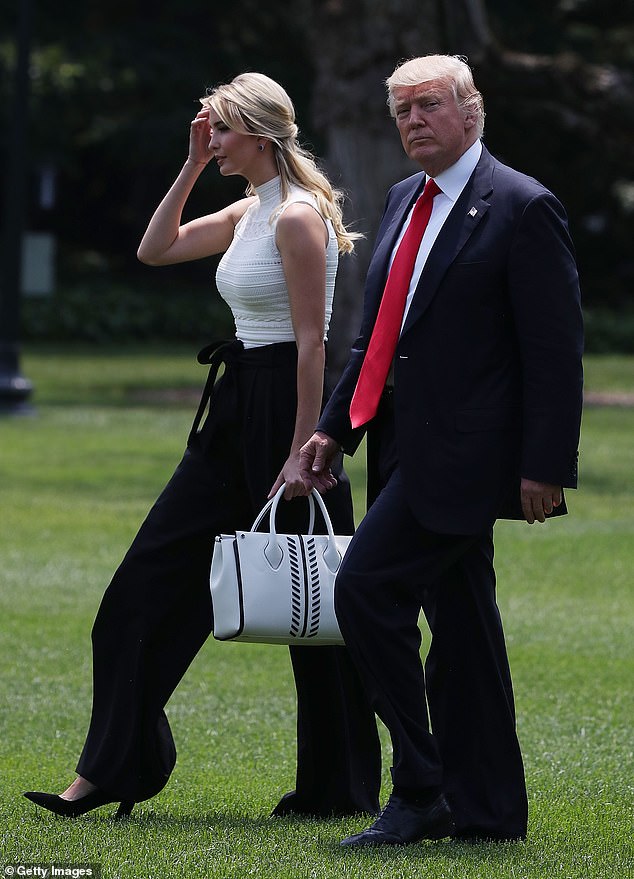 President Donald Trump and daughter Ivanka Trump walk toward Marine One before leaving the White House in Washington, DC on June 13, 2017.