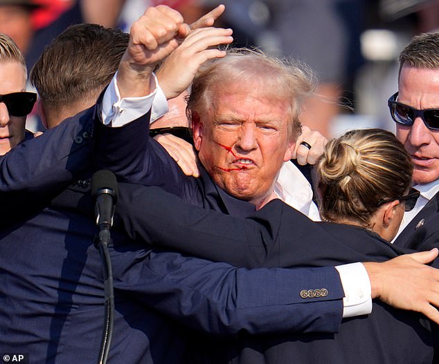 Trump remained defiant after the attack, energetically raising his fist in the air to the crowd