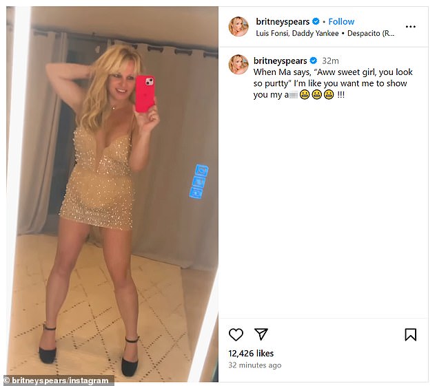 In a post, the pop star modeled a sheer, mesh mini dress covered in rhinestones, worn over a plunging, nude corset bodysuit. She wrote a provocative caption for the clip