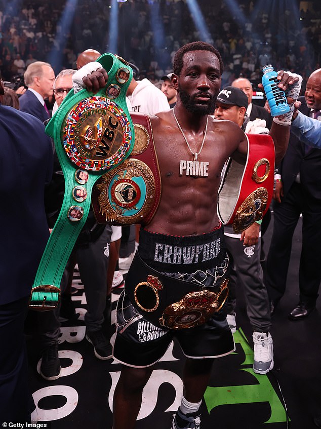 Crawford gets his arm raised by referee Harvey Dock after defeating Errol Spence Jr. in 2023