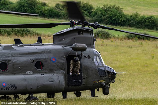 Boeing CH-47D ZA 671 is guarded by the RAF in the middle of a field in Bere Regis, Dorset