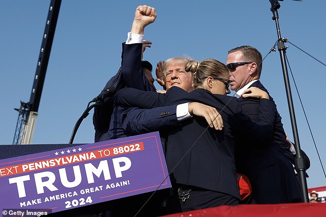 US intelligence officers swarmed Trump before he stood up in a display of defiance captured in a photo seen around the world