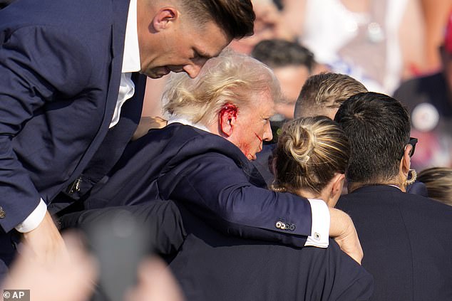 Blood can be seen flowing from the side of the former president's head