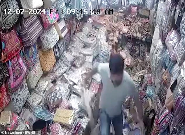 As the man leaves, surveillance footage shows the fabric store in ruins