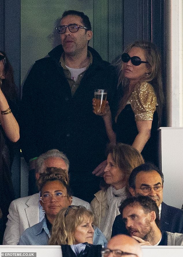 She held a beer while watching the performance