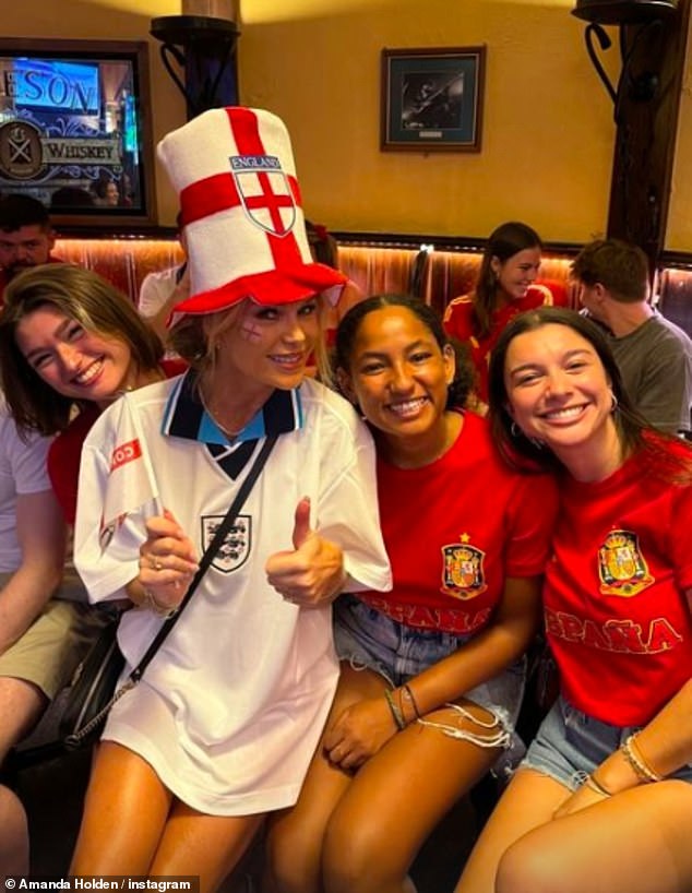 She posed with some Spanish supporters while enjoying a drink in a pub