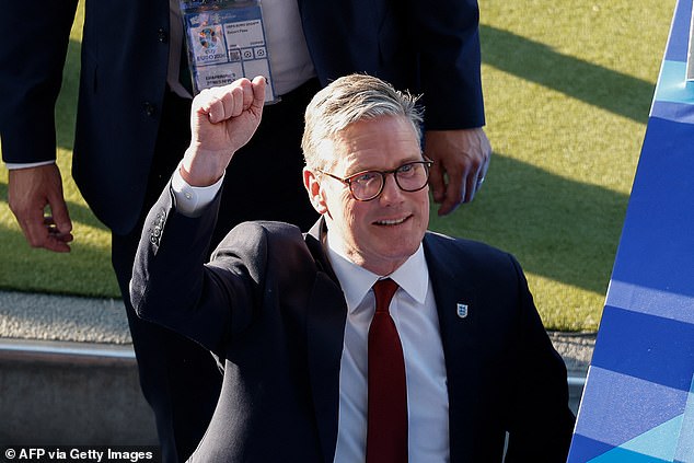 British Prime Minister Keir Starmer waves to England fans as they arrive for the big match