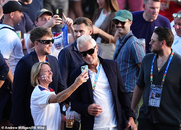 Martin posed for photos with fans before the match started