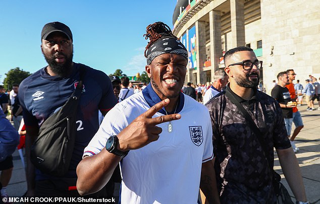 KSI threw a peace gesture as he posed with friends outside the UEFA European Championship in his white and blue England shirt