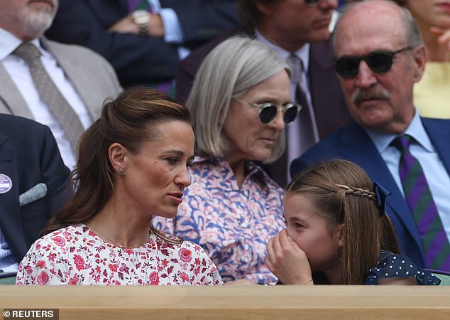 At one point in the match, Charlotte was pictured whispering happily to her aunt and covering her mouth with a hand