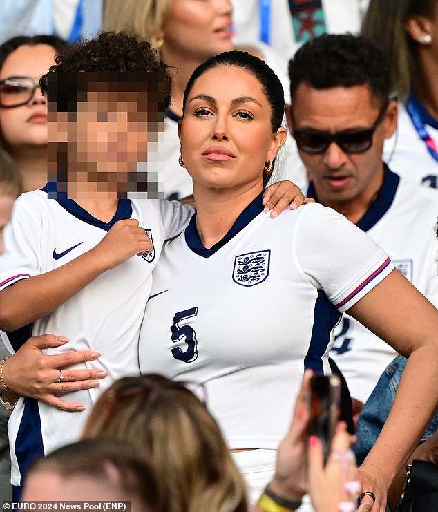 Olivia Naylor even posed with her hand on her hip as she joined the crowd to support John Stones