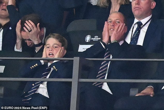 Pictured: Tense Prince William and Prince George with their heads in their hands during the match