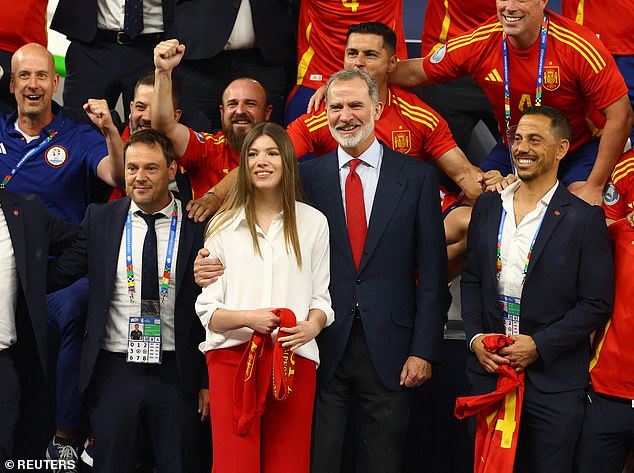 Felipe lovingly puts his arm around his youngest daughter as they celebrate the victory