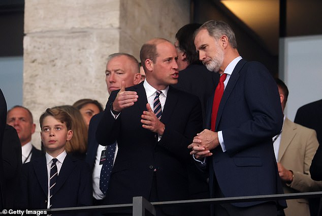 William and George - second in line to the throne - also put on a fashion show, as they wore matching striped ties in the colours of the England national football kit, white and red.