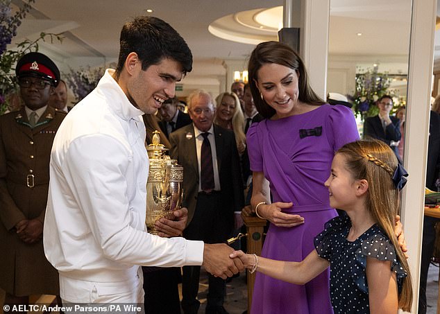 Winning smiles: Princess Charlotte shakes hands with the winner as Kate looks on after Carlos Alcaraz's victory over Novak Djokovic