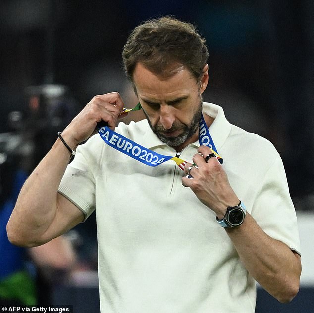 Southgate is pictured handing over his runners-up medal after Sunday's disappointing defeat