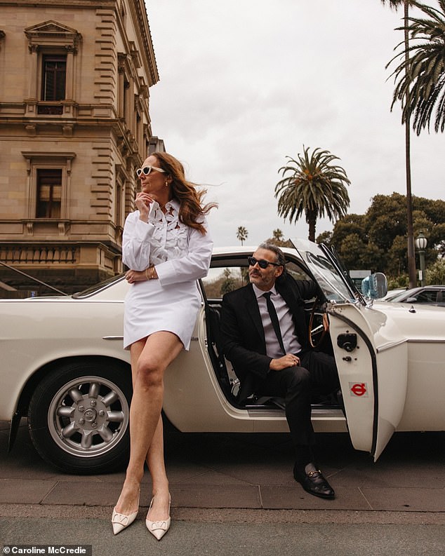 The couple posed for photos in front of Melbourne's Old Treasury Building and their 1967 P1800 Volvo wedding car