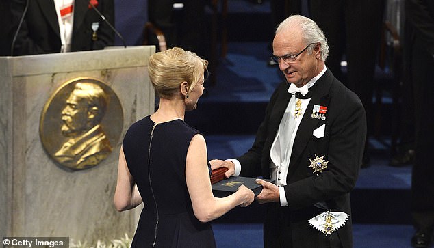 Alice Munro, winner of the Nobel Prize for Literature, represented by her daughter Jenny Munro (L), receives her Nobel Prize from King Carl XVI Gustaf of Sweden in 2013